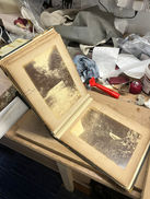 A different angle of an old book with photos.