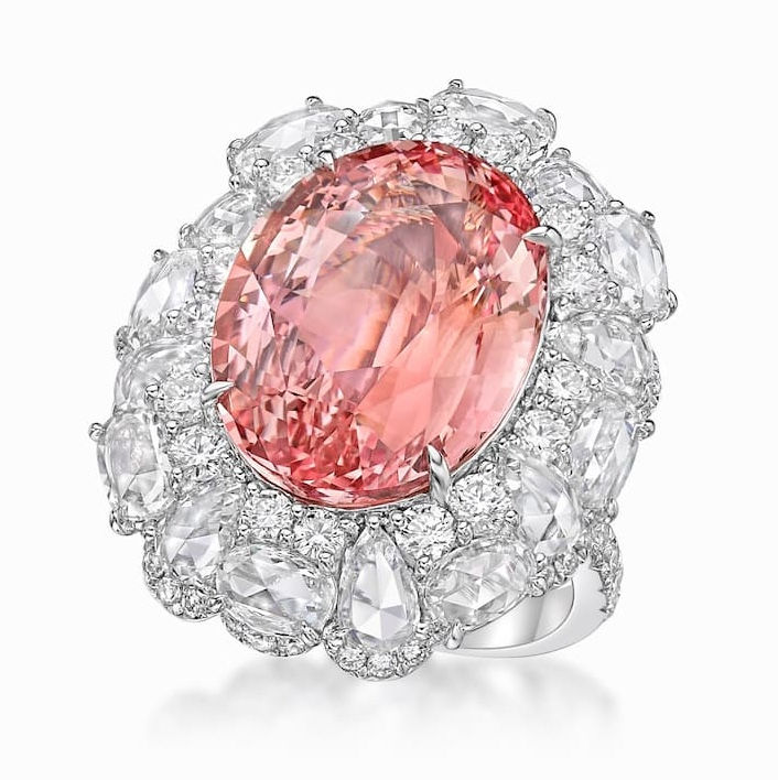 Close-up view of a rare pink-orange padparadscha sapphire gemstone