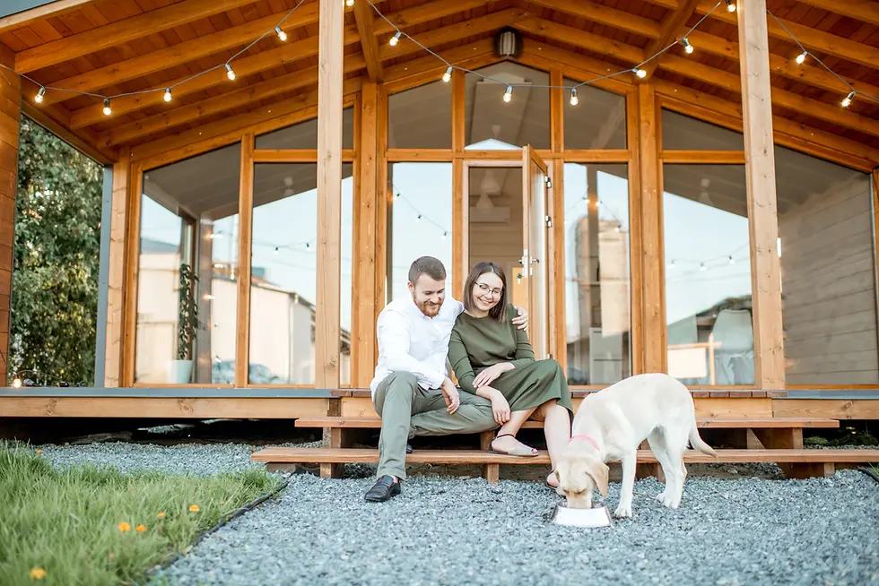 couple with dog near the house
