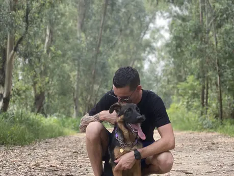 man and dog in forest