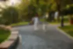 woman with dog running in park