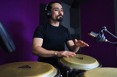 Guillermo Barrón recording congas in his studio