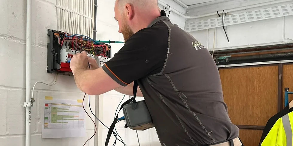 Electrician in Camberley working on a fuse box.