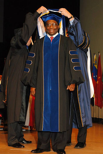 Hooding of Dr. Umoh at his PhD ceremony.