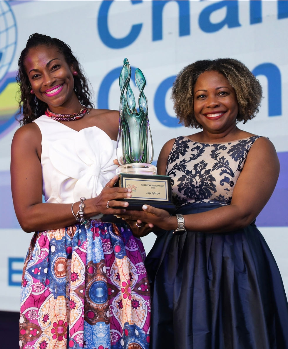 Gabrielle Burgess of Suga Lifestyle receiving the JCC Entrepreneur of the Year Award from Senator-turned-Minister of Education, Dr. the Hon. Dana Morris Dixon.