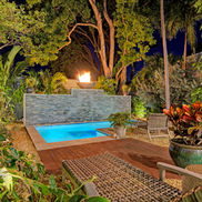 Luxury vacation rental exterior night time with a sparkling pool in Siesta Key, Florida.
