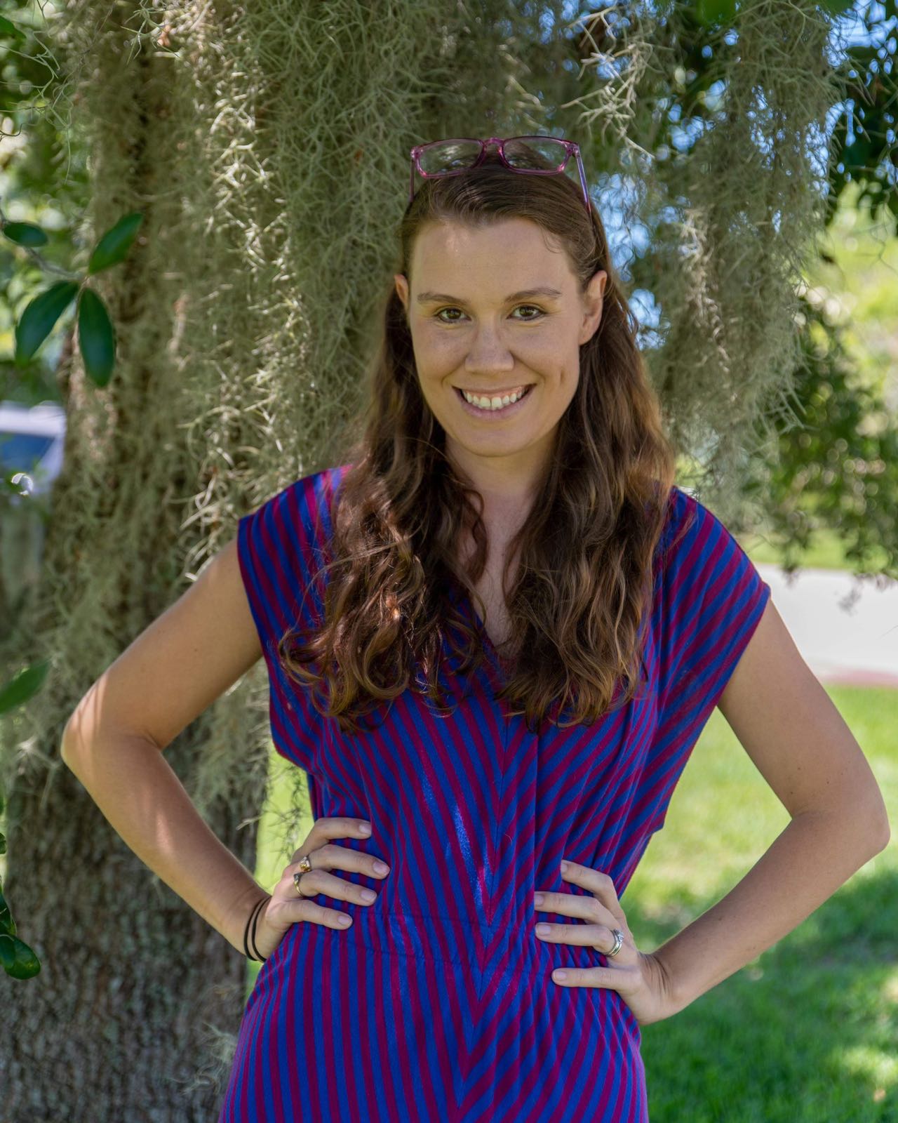 English instructor smiling in an outdoor professional headshot.