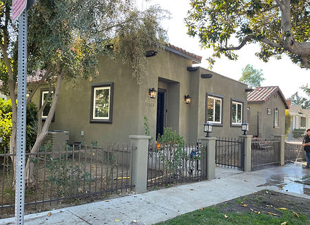 Finished home exterior with gated entry, front walkway, and residential remodel design