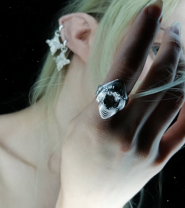 Ethereal elf wearing ornamental psychedelic jewelry: ring and earrings