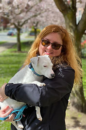 Keeley Treloar holding small white dog.