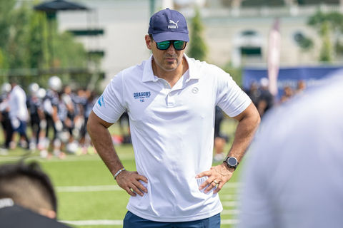 Person in sports attire with hands on hips.