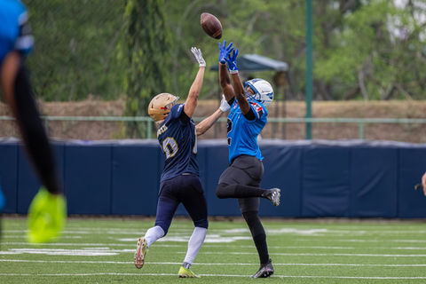 Two football players competing for the ball.