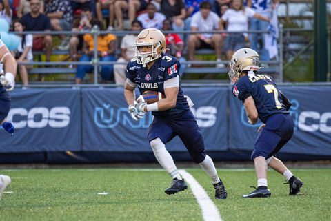 Football player running on the field during a game.