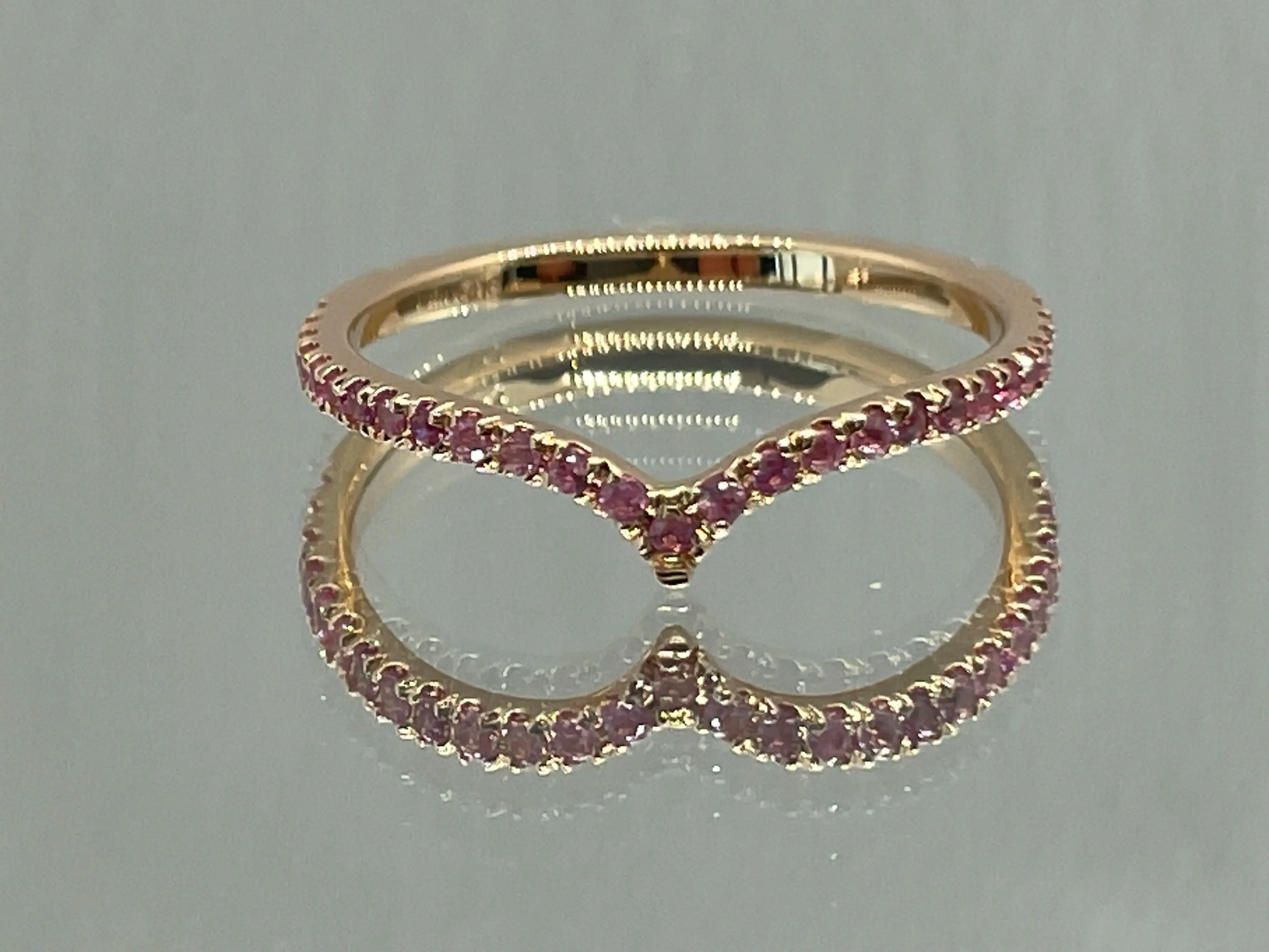 Custom 14K red gold ring with natural pink sapphires. Luxury handmade jewelry with expert gemstone setting.