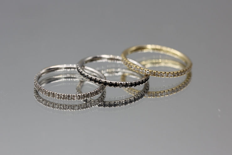 14K white and yellow gold rings, set with white and black diamonds all around. Custom jewelry. Expert diamond and gemstone setting. Jewelry repair in Toronto.