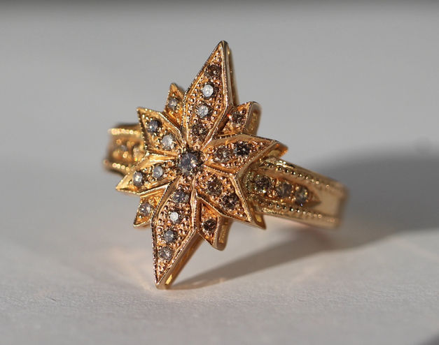 Custom 18K rose gold Red Star ring with cognac-colored diamonds. Expert diamond and gemstone setting. Jewelry repair in Toronto available.
