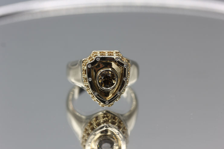 Custom white and yellow gold men’s Royal Shield ring with champagne diamond. Luxury handmade jewelry. Jewelry repair in Toronto available.