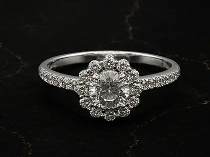 Custom engagement ring in 18K white gold with natural diamond center, halo and pavé diamond band