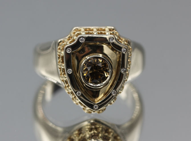 Custom white and yellow gold men’s Royal Shield ring with champagne diamond. Luxury handmade jewelry. Jewelry repair in Toronto available.