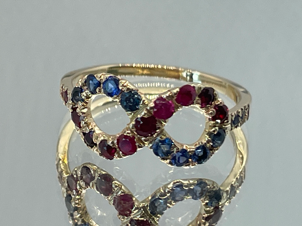 Infinity ring in 14K yellow gold with natural rubies and sapphires, custom jewelry, luxury handmade jewelry, diamond and gemstone setting.