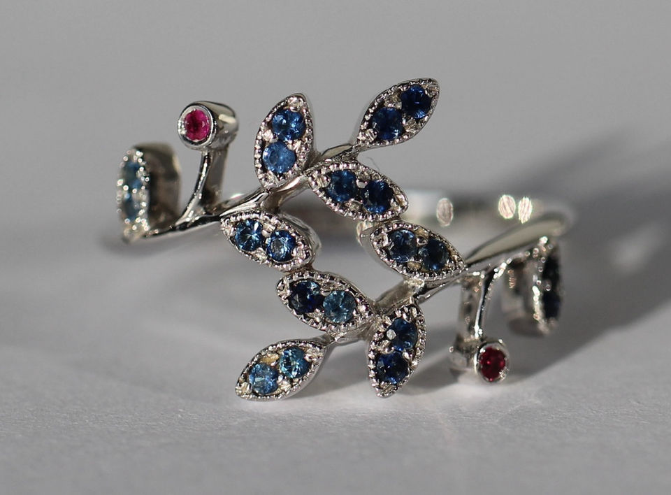 Custom-designed 14-carat white gold ring with sapphires and rubies, luxury handmade jewelry.