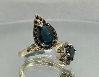 Designer ring in 14K yellow and white gold featuring natural dark oval and pear-cut tourmalines, natural white and black diamond halos, handcrafted by Marchioness Jewelry Boutique, custom jewelry Toronto.