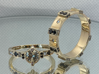 Two men’s 14K yellow and white gold rings with natural white and black diamonds, “Architectural Rhythm” and “Sovereign Light”, handcrafted at Marchioness Jewelry Boutique — luxury handmade jewelry, Custom Jewelry Toronto, high-precision diamond & gemstone setting.