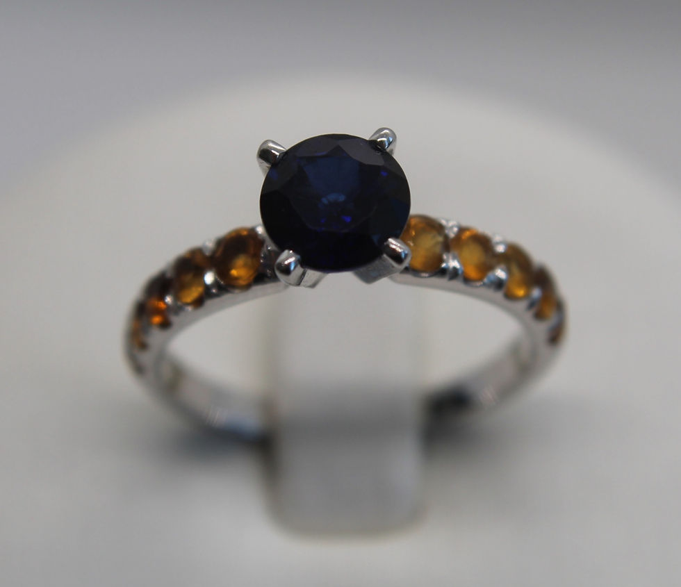 Custom 14K white gold ring with natural blue and yellow sapphires. Luxury handmade jewelry featuring vivid gemstones.
