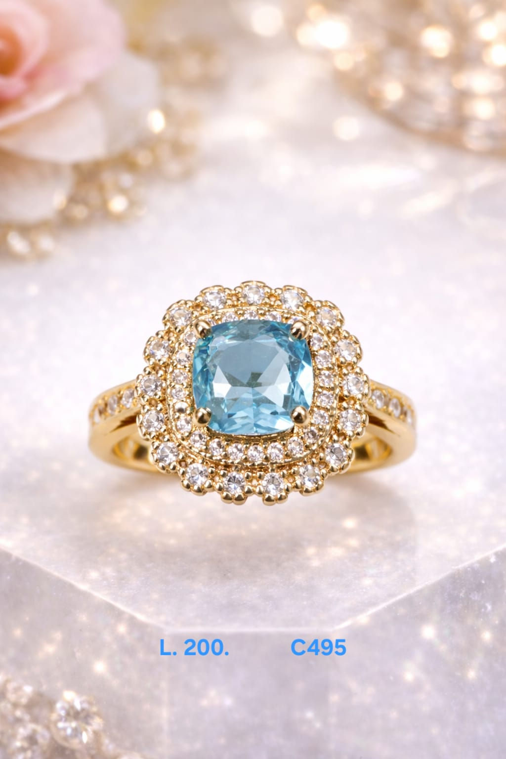 Anillos laminado de oro 18k con gema central azul aguamarina y doble halo de bri