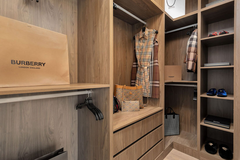 Walk in closet with custom wood shelving in Etobicoke luxury home