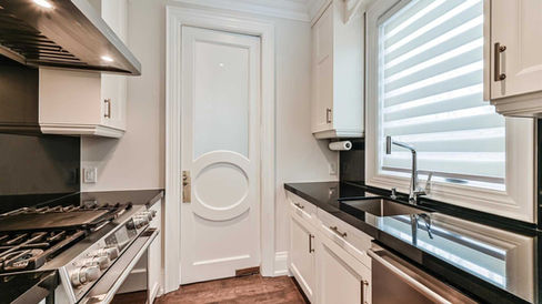 Modern galley custom home kitchen with white cabinets and quartz countertops built by Toronto custom home builder 416 Construction.