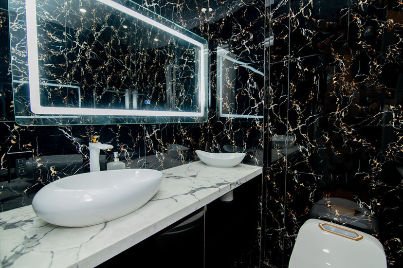 Luxury bathroom with black marble walls and modern vanity in Etobicoke custom home