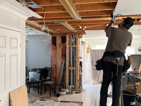 Load-bearing wall removal during a Toronto home renovation, with structural framing and temporary supports installed to create an open-concept living space.