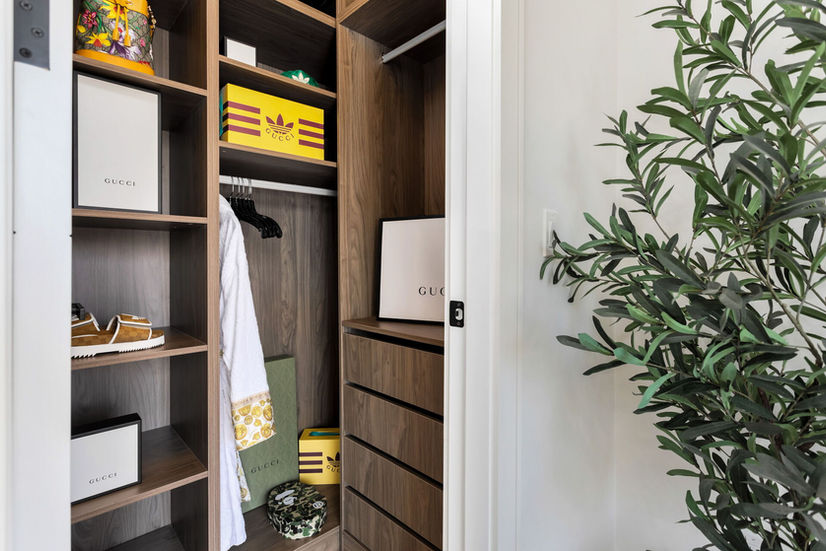 Custom walk in closet with built in shelving in Etobicoke luxury home