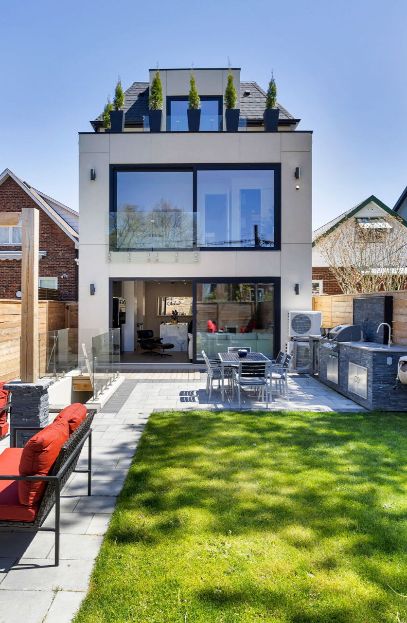 Large energy-efficient windows filling a modern Toronto custom home with natural light.
