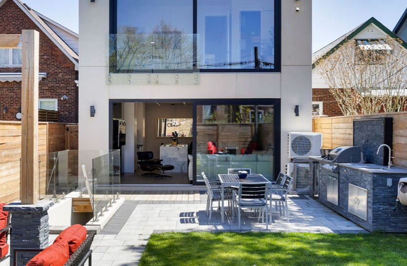 Large energy-efficient windows filling a modern Toronto custom home with natural light.