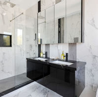Luxury marble bathroom in a Toronto custom home with large tiles, glass shower, and modern vanity.
