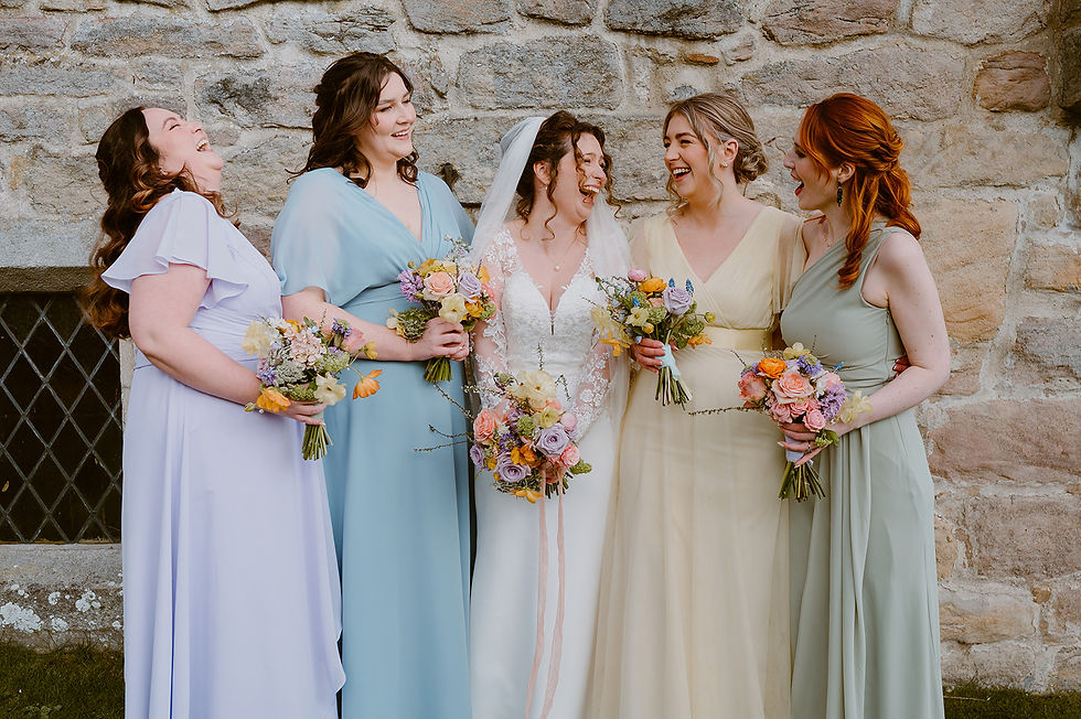 pastel bridesmaids dresses and flowers at the priest's house skipton
