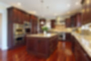 Traditional Kitchen with Dark Mahogany Cabinets, Stainless Steel Appliances, and Beige & Black Mottled Granite