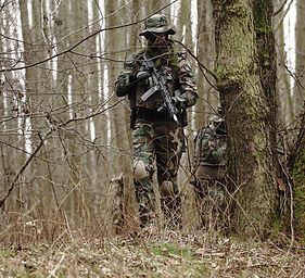 man holding rifle near the tre_edited.jpg
