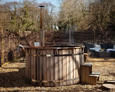 Wood-fired-hot-tub-at-Melancoose-Mill-woodland-spa.webp