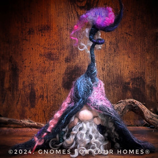 A whimsical needle-felted gnome in a triangular dress shape, made of black wool with swirling accents in pink, purple, and turquoise. The figure has a distinctive upward-curving profile with white curly wool hair and a pointed black hat. The piece has an ethereal, fairy-tale quality and appears to be a decorative gnome or witch figure. A watermark reads '© 2024, GNOMES FOR YOUR HOMES®'"