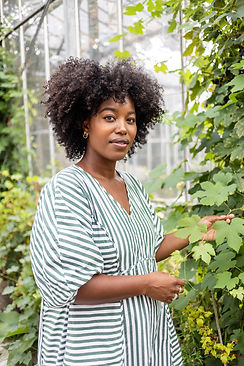 black woman striped dress in front of grape vines portrait photographer brighton