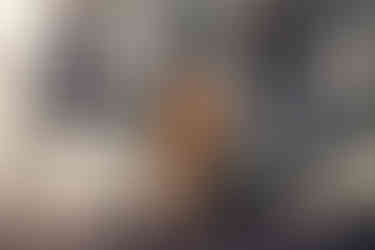 White woman with blonde bob and brown shirt standing in front of wooden building Professional headshots Brighton