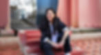 portrait photographer Brighton woman with long dark hair black blazer tattoos in front of pink sculp