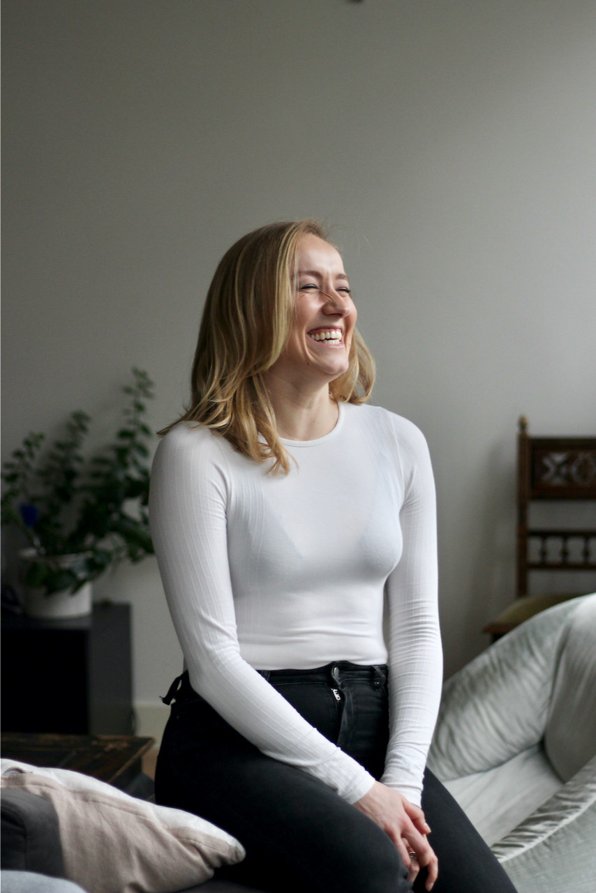 Blonde woman in white top laughing