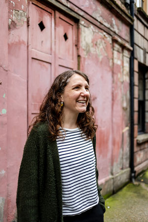 portrait photographer Brighton white woman in front of pink wall striped top