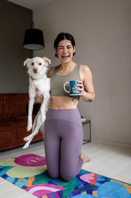 personal branding photographer Brighton white woman in purple yoga clothes holding a mug and a white dog