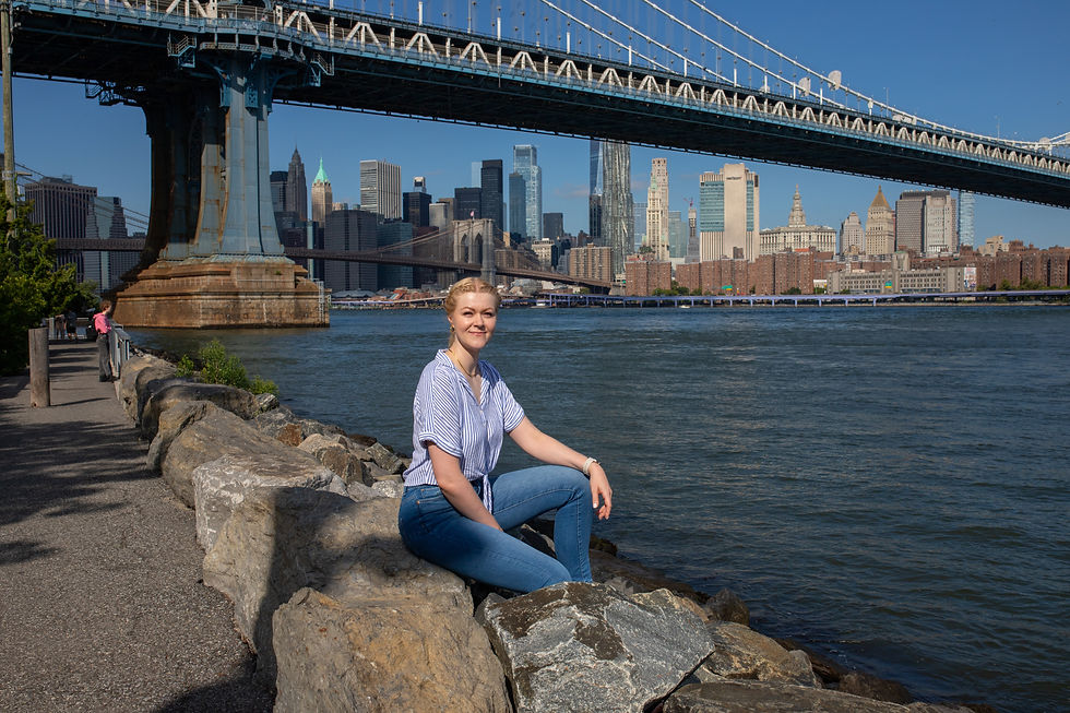 Woman enjoying a sunny day at Brooklyn Bridge Park, captured by a professional photographer.