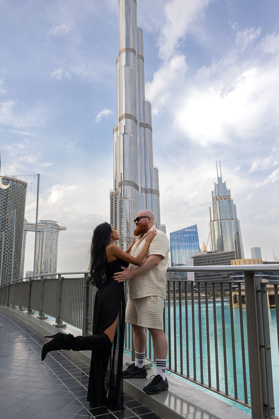 Romantic portrait of a couple during a travel photo session near the Burj Khalifa, blending modern urban vibes